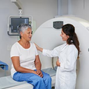 Physician comforting patient about to enter an MRI machine