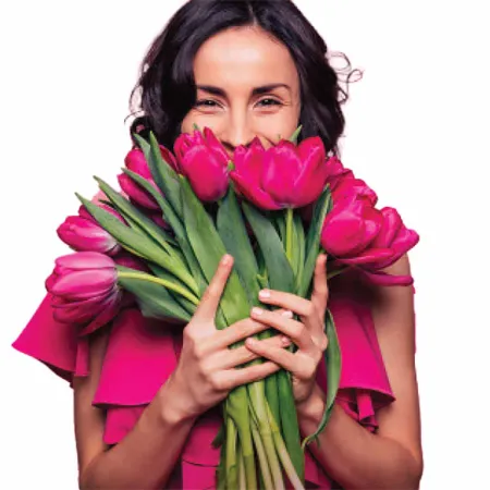 Woman smelling pink roses